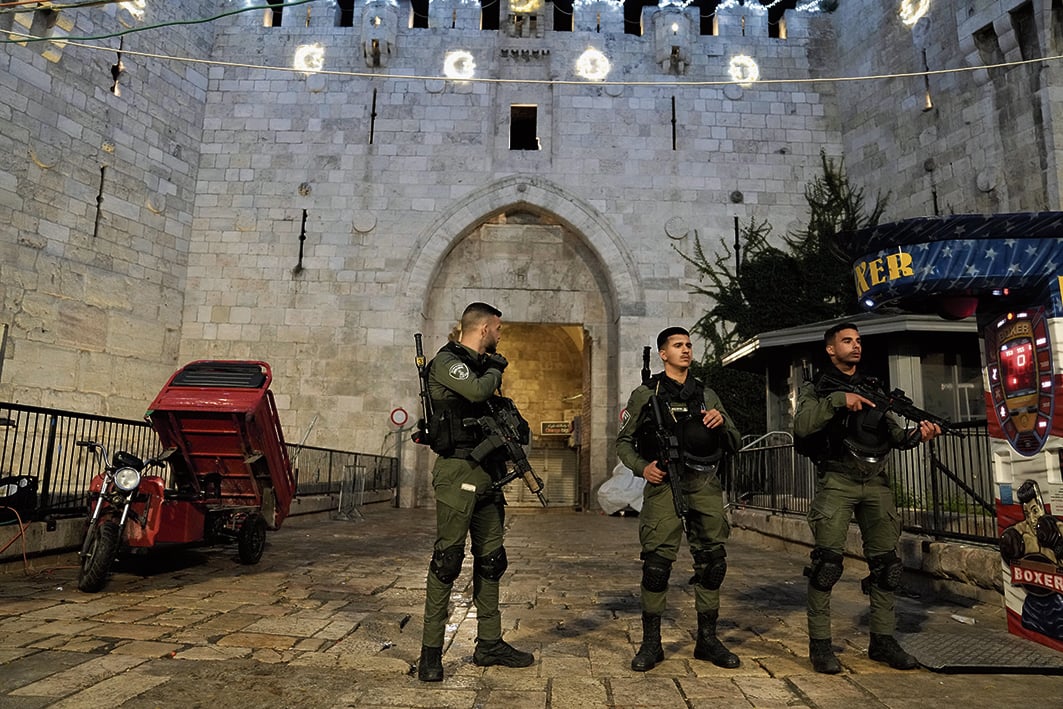 Israeli Border Police are deployed at Damascus Gate to the Old City of Jerusalem during a raid by police at the Al-Aqsa Mosque compound, Wednesday, April 5, 2023. Palestinian media reported police attacked Palestinian worshippers, raising fears of wider tension as Islamic and Jewish holidays overlap.(AP Photo/Mahmoud Illean)