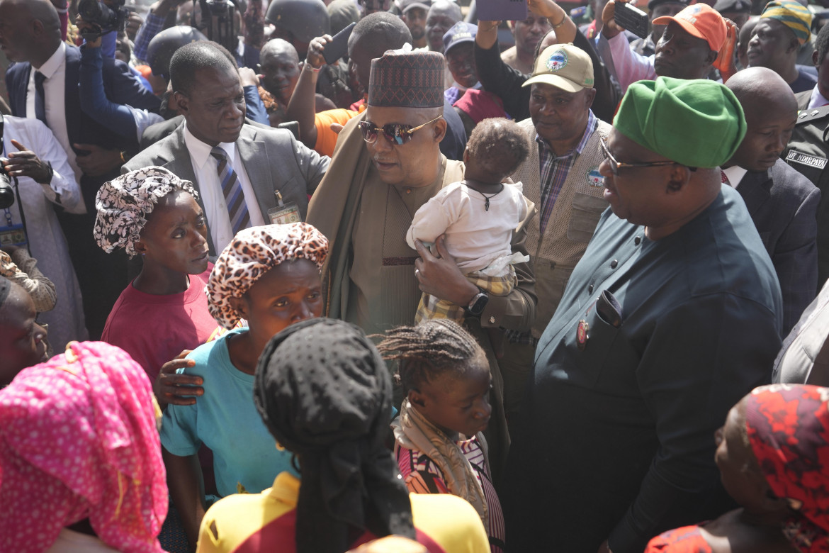 Nigeria Vice President, Kashim Shettima, centre, carries a baby, a victim of gunmen attacked at the internal displaced camp in Bokkos, north central Nigeria, Wednesday, Dec. 27, 2023