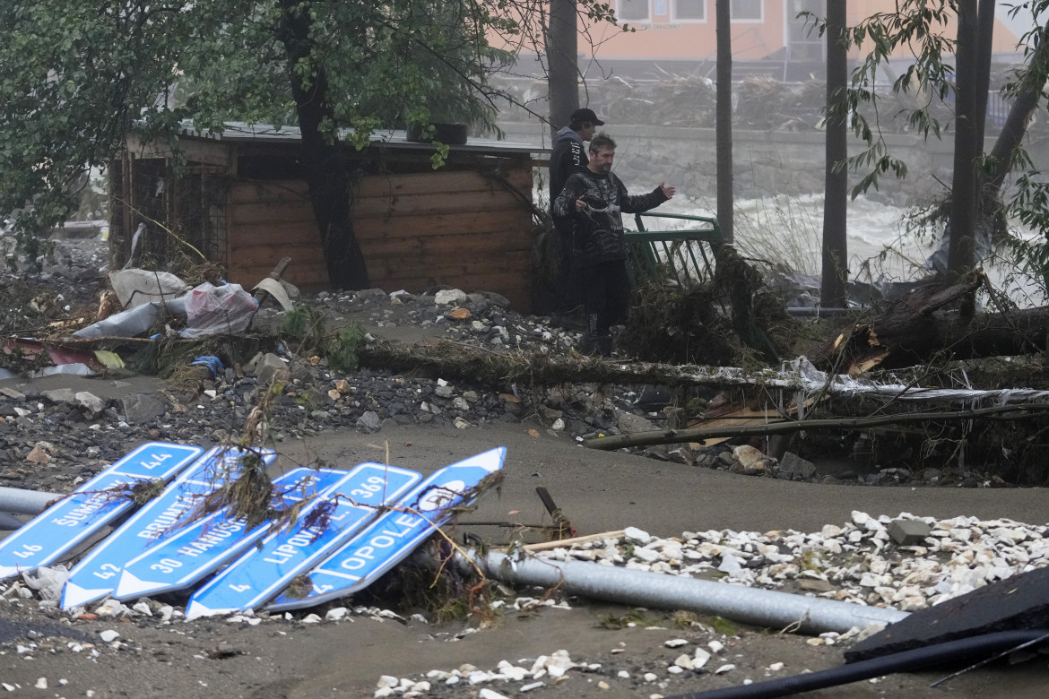 Residents look at the damage done by recent floods in Jesenik, Czech Republic, Monday, Sept. 16, 2024. (AP Photo/Petr David Josek)