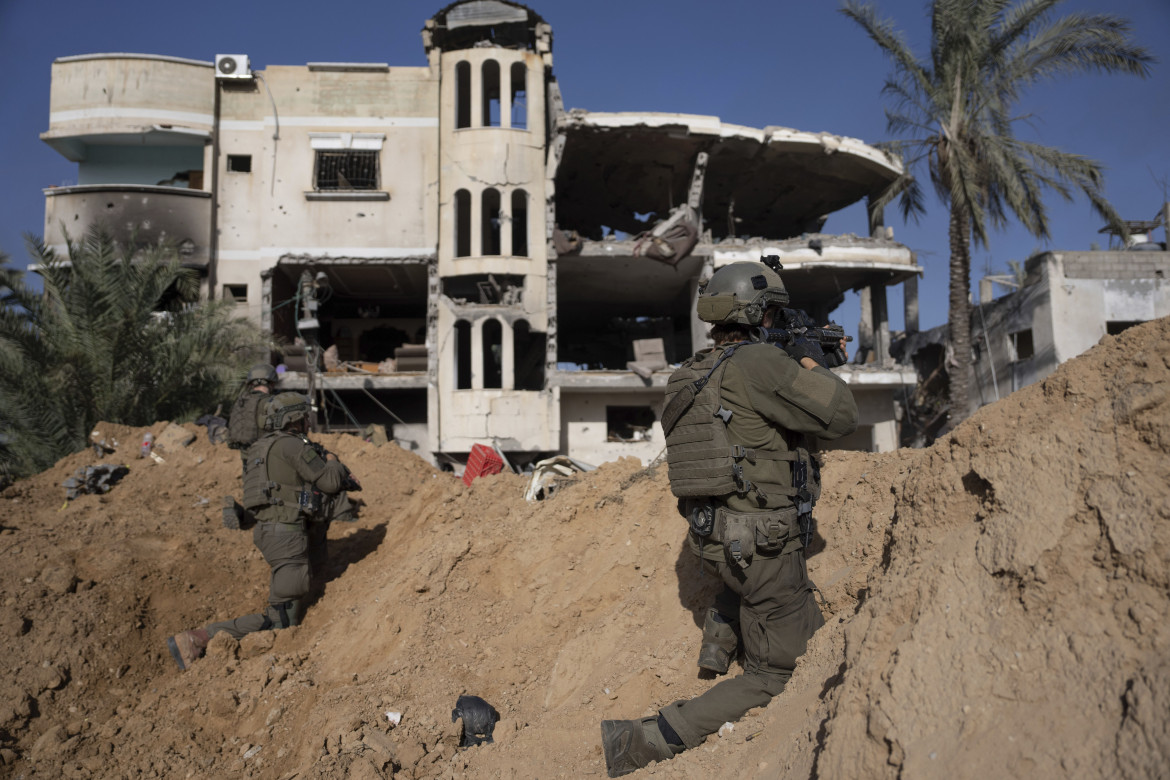 Soldati israeliani prendono posizione accanto a un edificio distrutto a Khan Younis, Gaza foto di Ohad Zwigenberg/Ap