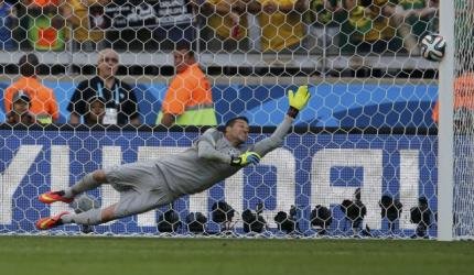 Brazil’s Cesar dives as the ball shot by Chile’s Jara rebounds off the post to decide their penalty shootout in their 2014 World Cup round of 16 game at the Mineirao stadium in Belo Horizonte