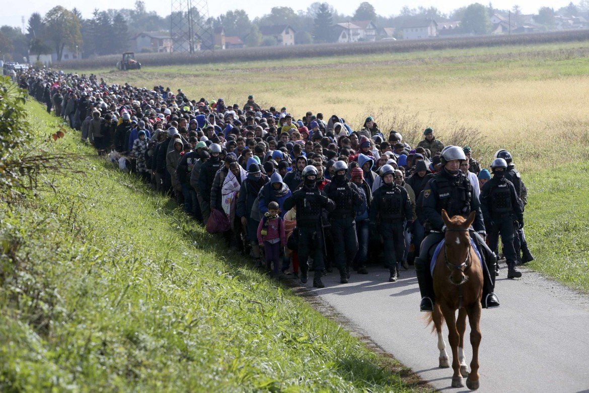 no inserto A mounted policeman leads a group of migrants near Dobova Slovenia October 20  2015 slovenia croazia