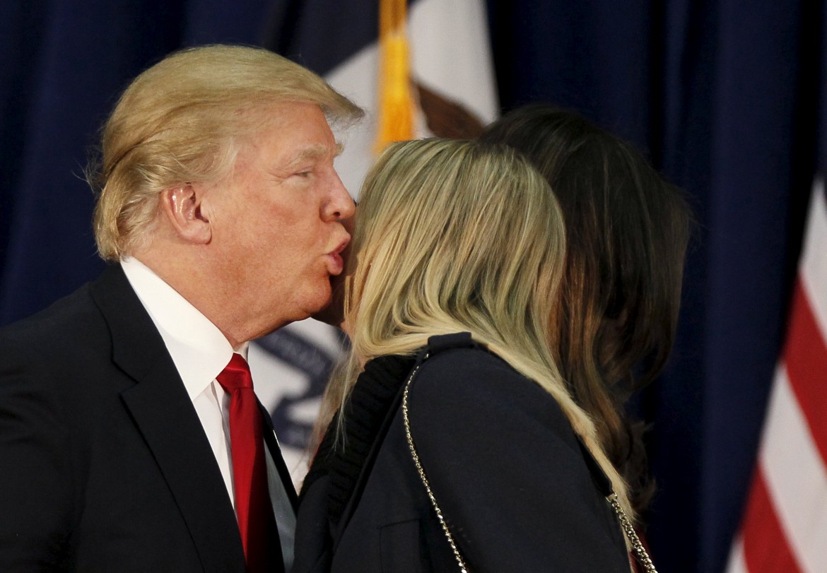 Donald Trump kisses his daughter Ivanka as he speaks at a campaign rally on caucus day in Waterloo Iowa February 1 2016 REUTERS-Rick Wilking