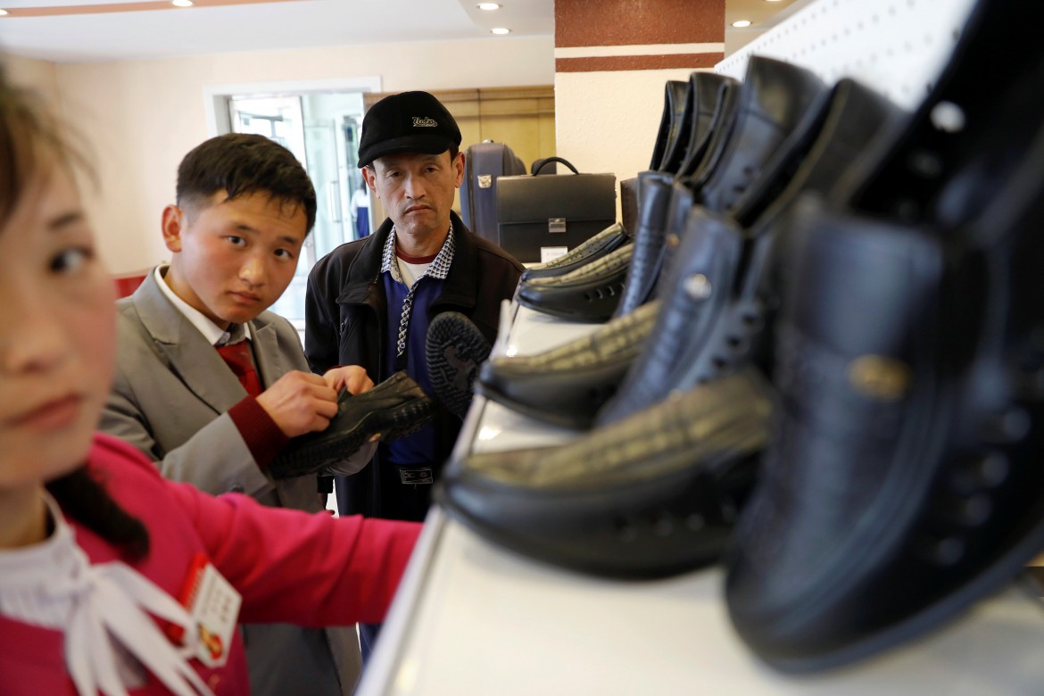 People check shoes in a shop in a newly constructed residential complex after its opening ceremony in Ryomyong street in Pyongyang, North Korea April 13, 2017.  REUTERS/Damir Sagolj