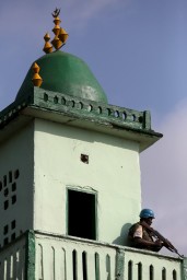 A United Nations peacekeeper stands guard on a minaret of the central mosque in the mostly Muslim PK5 neighbourhood of the capital Bangui, Central African Republic, during the visit of Pope Francis November 30, 2015. REUTERS/Siegfried Modola