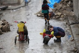 Children play on a street in Old Aleppo, January 3, 2015. REUTERS/Nour Kelze